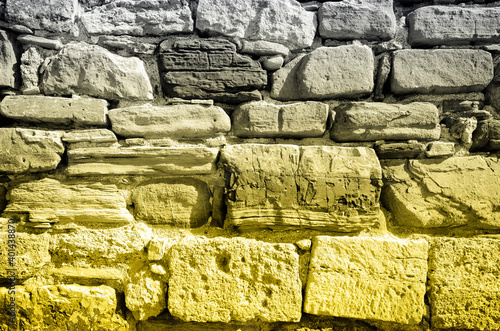 Pattern with brick wall in two trendy colors of 2021 year illuminating ultimate gray for wallpaper design. Yellow background. Horizontal wallpaper, background. Exterior brick wall texture background.