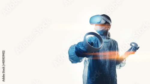 Obraz na płótnie woman doctor in a helmet of viotual reality with manipulators in hands on a white background. the concept of conducting remote operations using modern VR technologies w salonie