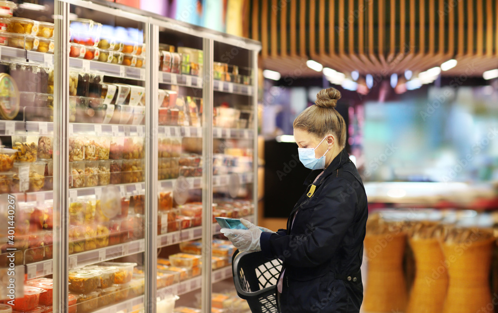 supermarket shopping, face mask,Woman choosing a dairy products at supermarket...