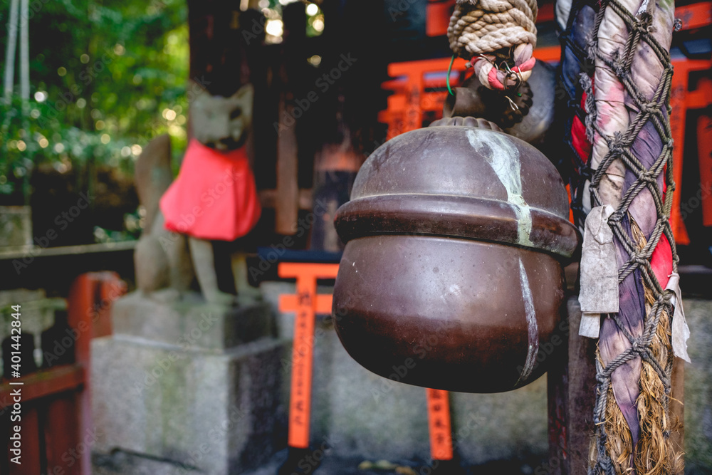 Great bell, torii gates, and a fox (kitsune) statue at Fushimi Inari taisha shrine, Kyoto Great bell, torii gates, and a fox (kitsune) statue at Fushimi Inari taisha shrine, Kyoto