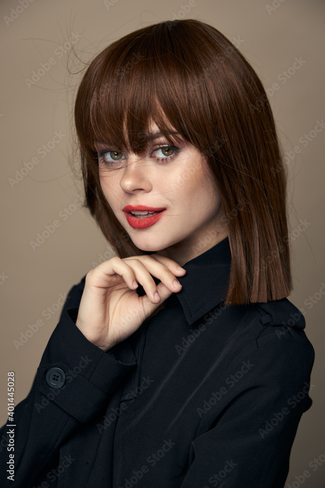 Luxurious brunette black coat elegant style laughing on an isolated background Luxurious brunette black coat elegant style laughing on an isolated background