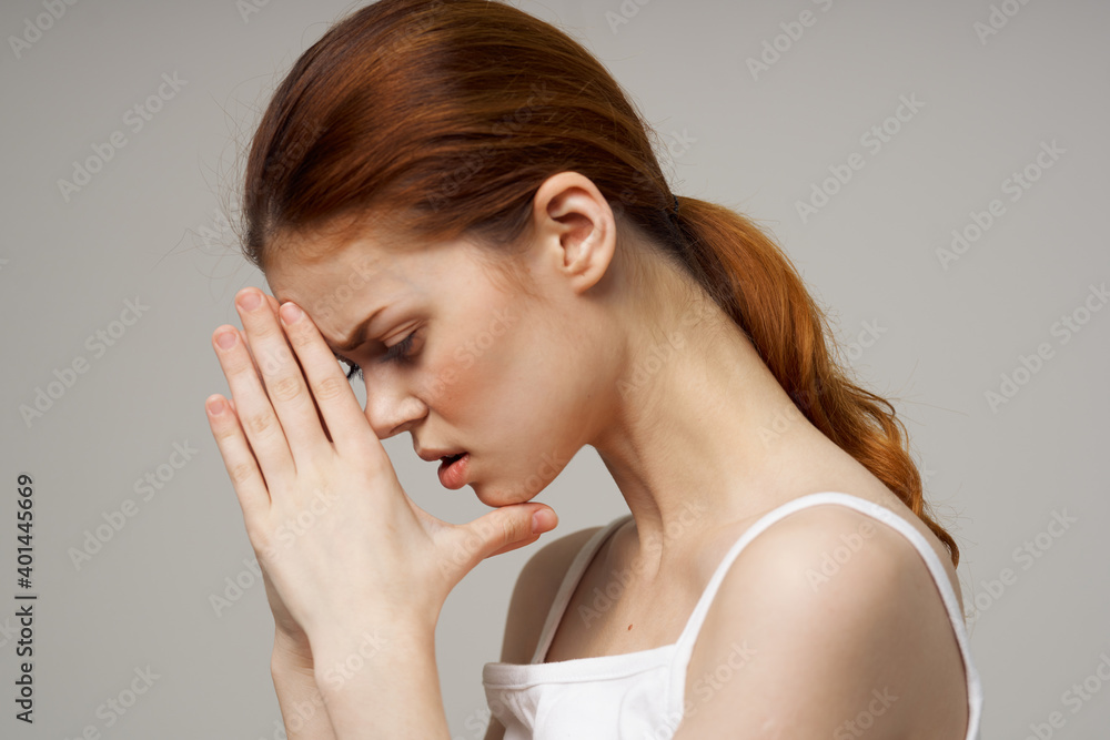 woman holding joined hands near face white t-shirt side view headache woman holding joined hands near face white t-shirt side view headache