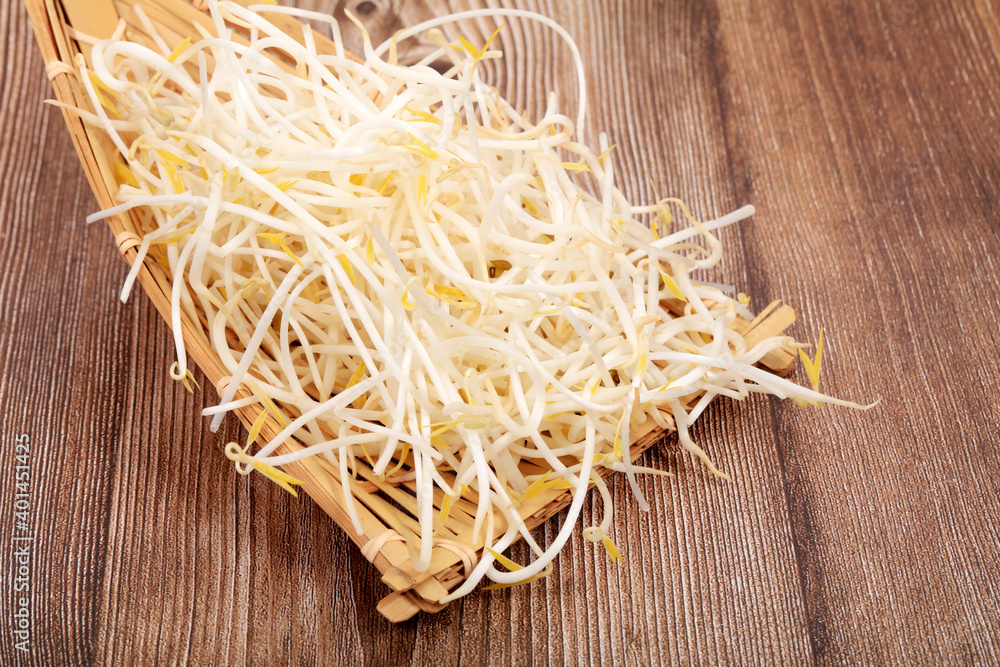 The mung bean sprouts are on the wooden table The mung bean sprouts are on the wooden table