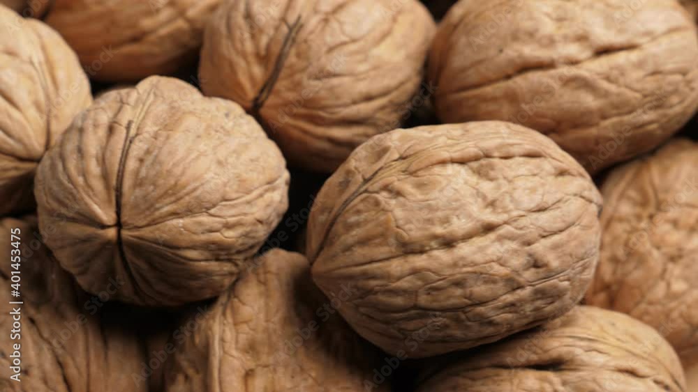 Whole Walnut closeup. Rotating nuts background, nobody Whole Walnut closeup. Rotating nuts background, nobody