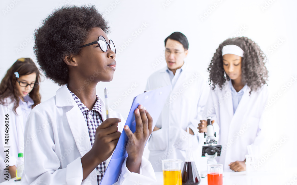 African black boy studying science in classroom at school African black boy studying science in classroom at school