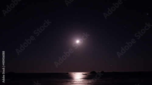 night sky with stars and moon on the sea