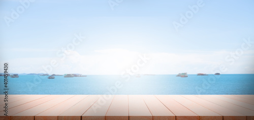 Wood perspective on sand beach with sea cocept. over light of old wood table on blur image of ocean with bokeh and sky. for travel summer holidays. © wing-wing
