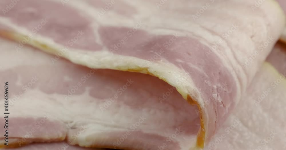 Truck shot close up of pile raw bacon texture on chopper board Truck shot close up of pile raw bacon texture on chopper board