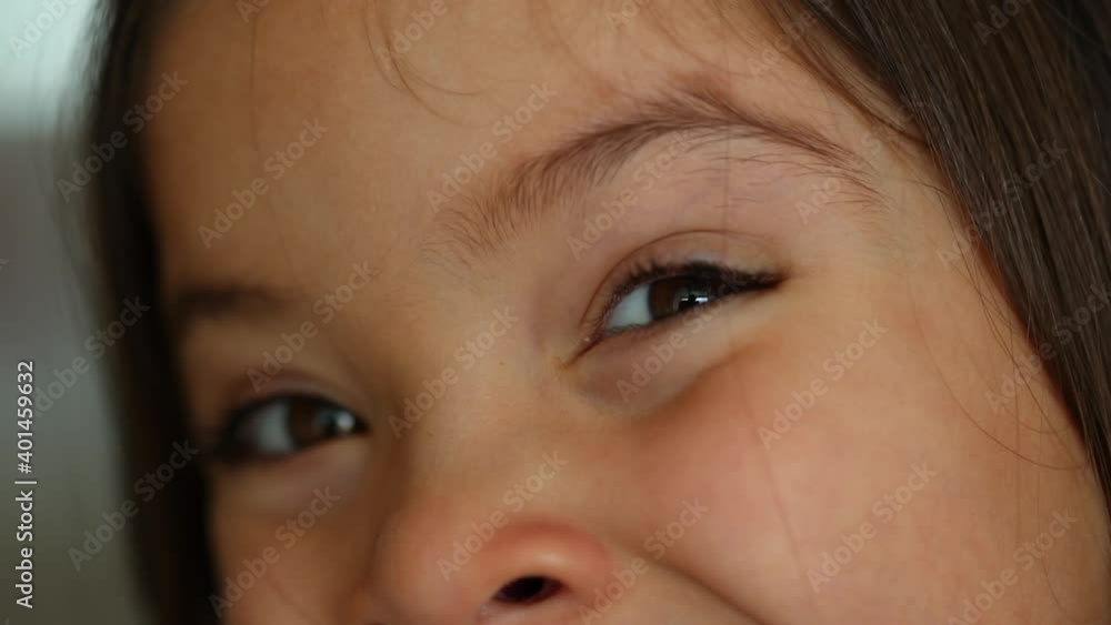 Happy little girl opening eyes to camera feeling pleased Happy little girl opening eyes to camera feeling pleased