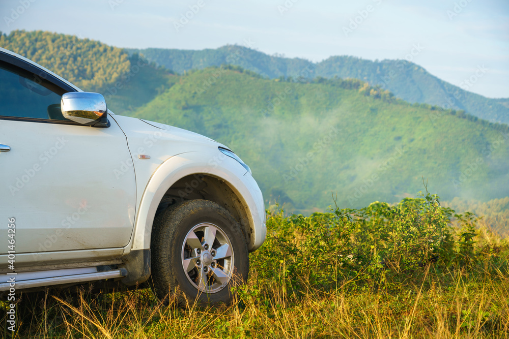 Outdoor travelling car on top hill with mountains on background in Asia