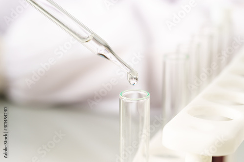 Scientist analyzing a blood sample on tray in laboratory