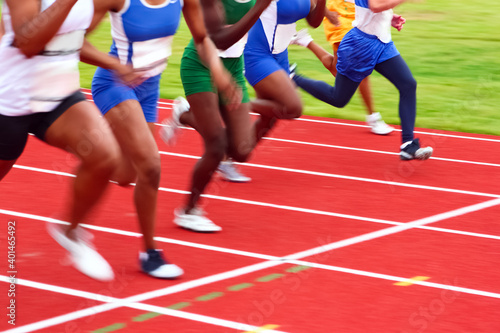Canvas Print Motion blurred image of women in a track and field sprint event