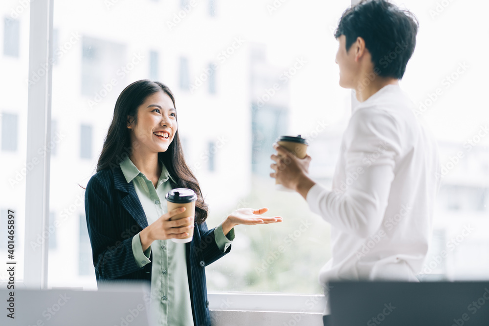 Businessman and businesswoman are discussing each other during lunch break Businessman and businesswoman are discussing each other during lunch break