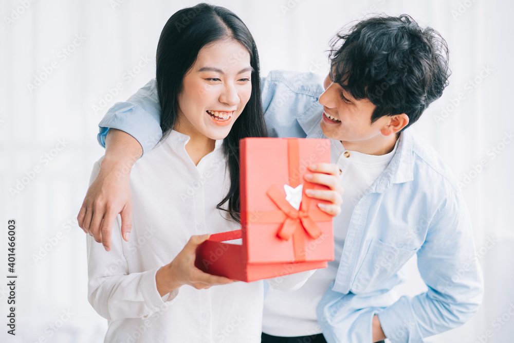 Asian girl feels happy and surprised to receive gifts from her boyfriend on valentine's day Asian girl feels happy and surprised to receive gifts from her boyfriend on valentine's day