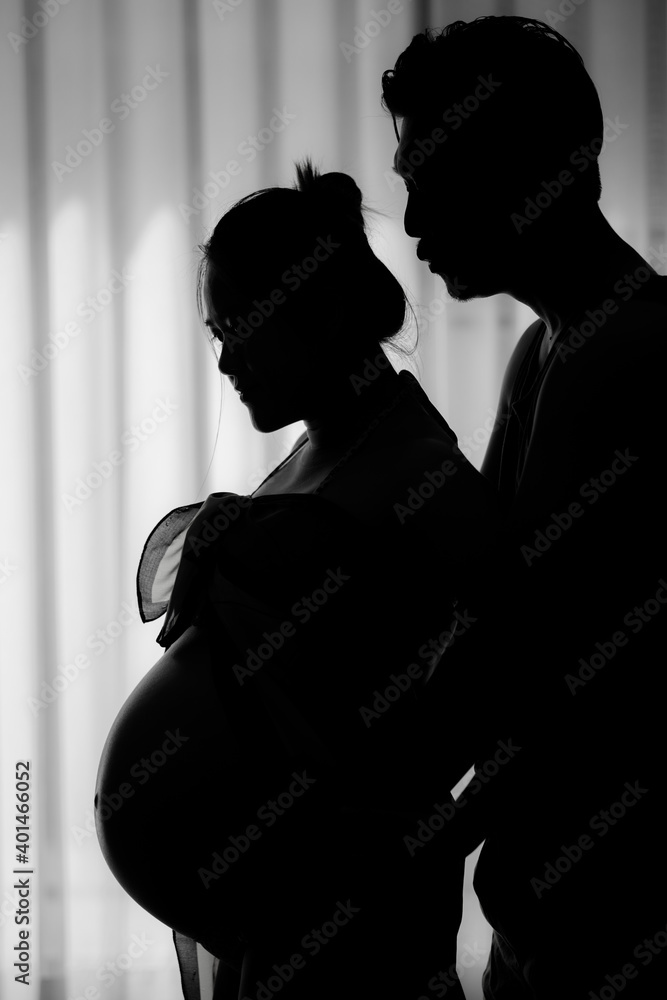 Forever love concept, Silhouette of Women pregnant and young couple. They are Prepare to be a new parent.