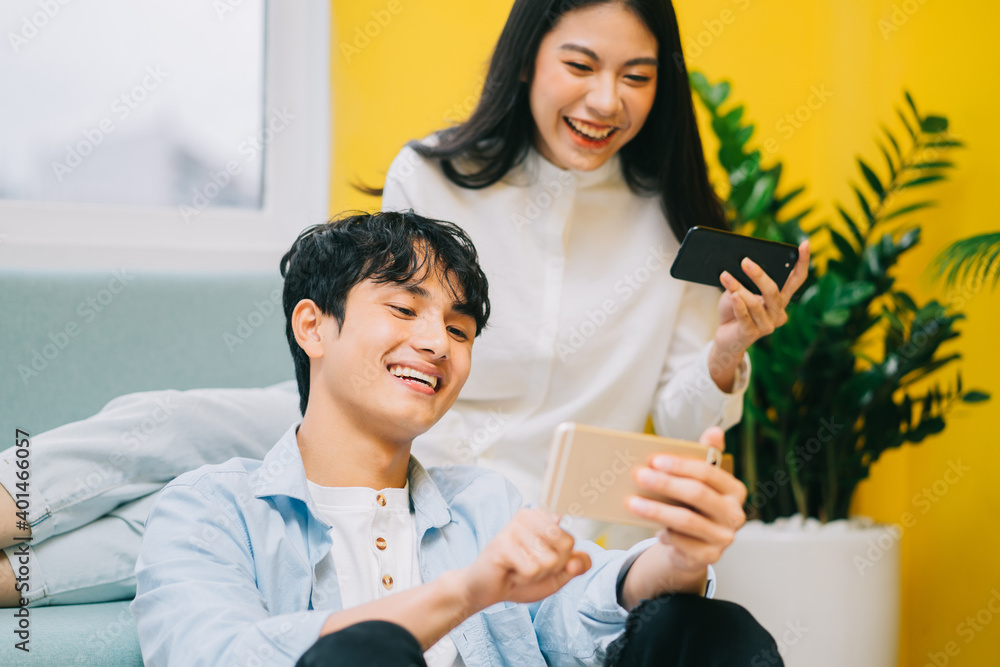 Asian couple playing games at home together, the happy life of a newlyweds
