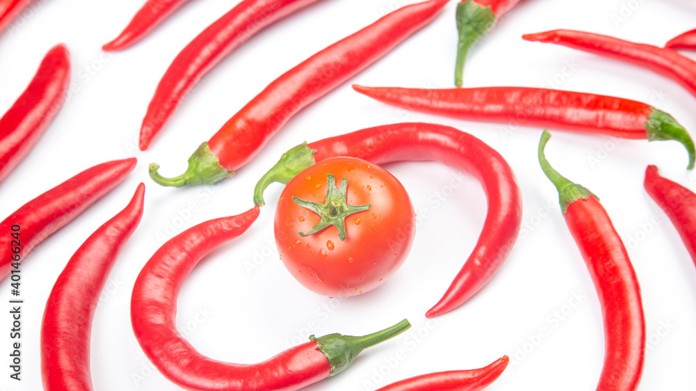 Red hot chili peppers and tomato over white background. Vitamin vegetable food