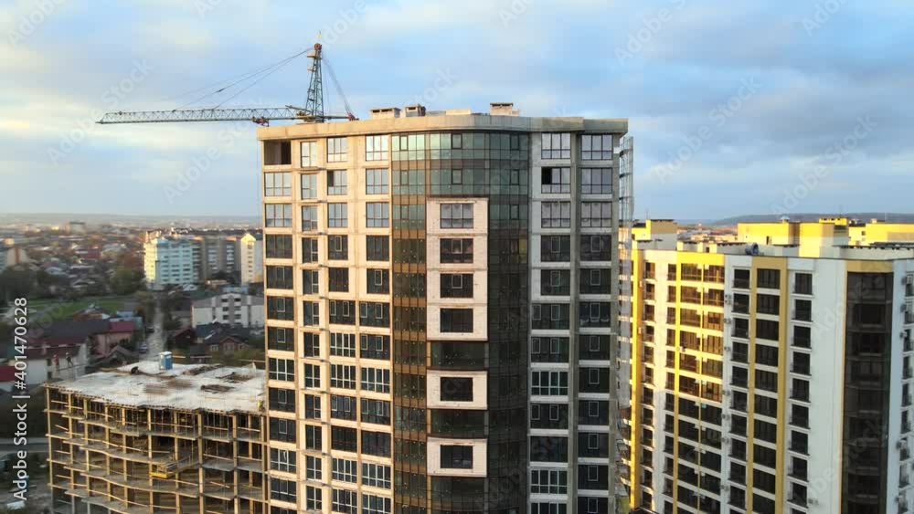 Aerial view of high residential apartment building under construction. Real estate development. Aerial view of high residential apartment building under construction. Real estate development.