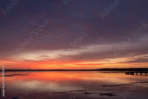 Fototapeta Naklejka Na Ścianę i Meble -  Colorful dawn sky with reflection on the water.
