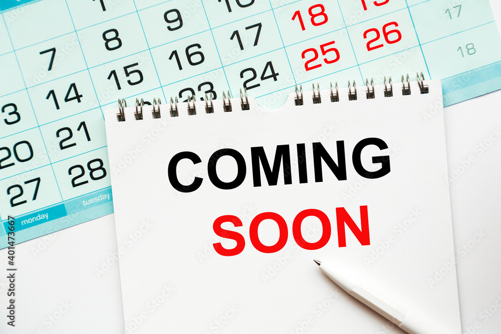 COMING SOON Abstract calendar close up background. Business concept written on notepad with space. COMING SOON Abstract calendar close up background. Business concept written on notepad with space.