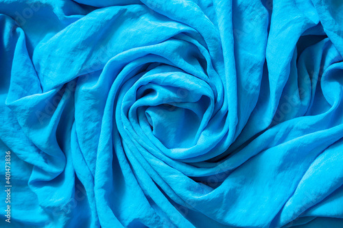 Top view of circular spiral fabric, blue silk fabric, blue cloth background, spiral swirl fabric, swirl cloth, Twisted background, twisted cloth.