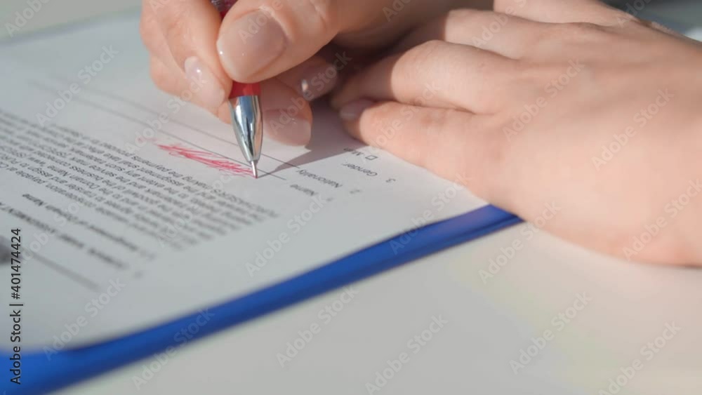 A man crosses out what is written with a red helium pen A man crosses out what is written with a red helium pen