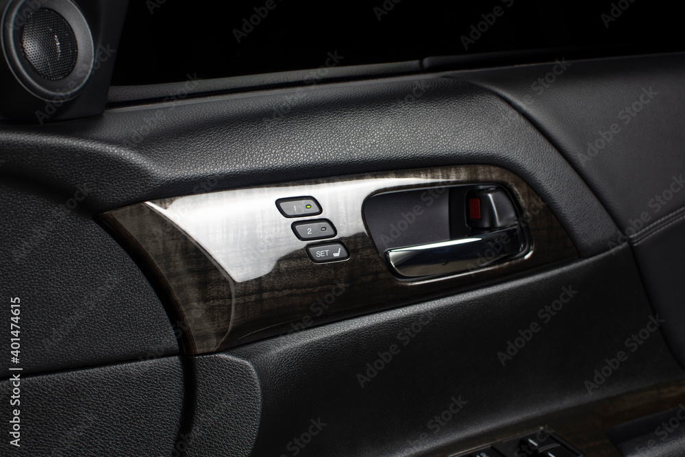 Driver seat memory button with two memory system for quick tilt adjustment and chrome door handle inside a luxury car