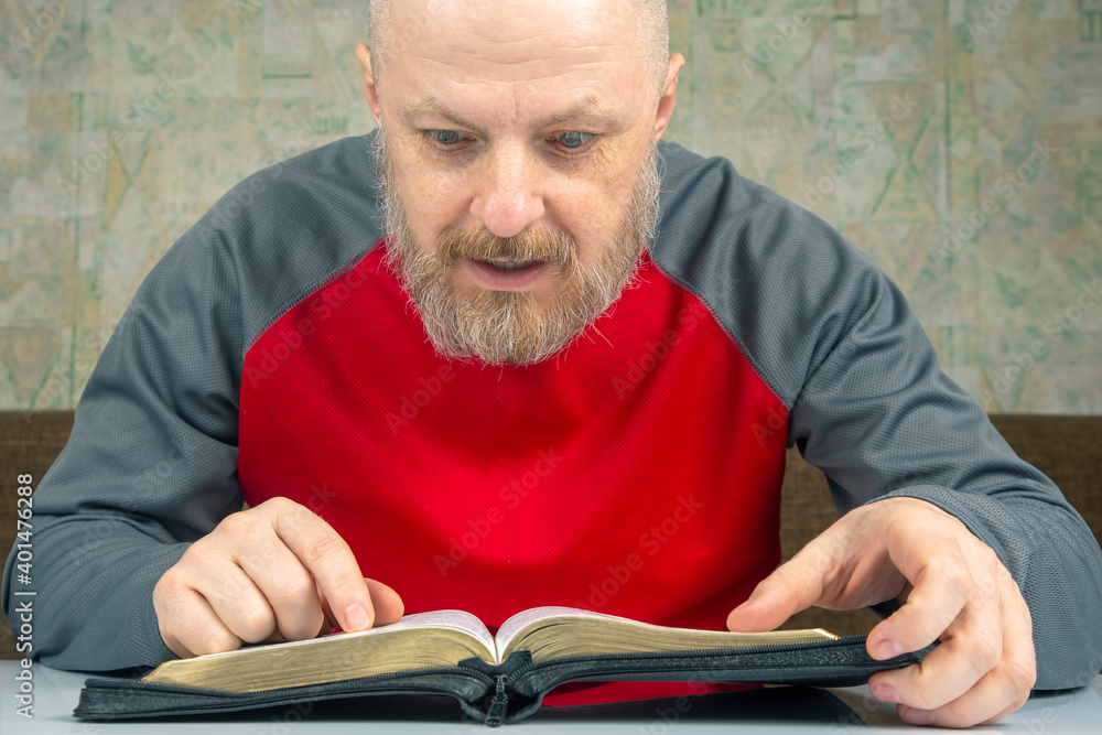 happy bearded man studies the Bible. religion and Christianity.