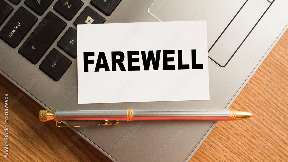 Notepad with the text FAREWELL is on the laptop keyboard. Minimal work space. Business concept. Notepad with the text FAREWELL is on the laptop keyboard. Minimal work space. Business concept.