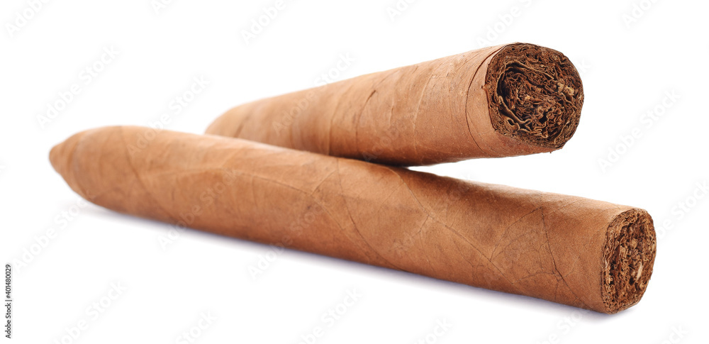 A pair of cuban handmade cigars torpedo isolated on white A pair of cuban handmade cigars torpedo isolated on white