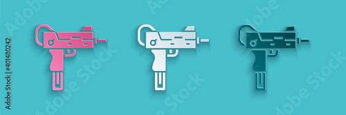 Paper cut UZI submachine gun icon isolated on blue background. Automatic weapon. Paper art style. Vector.
