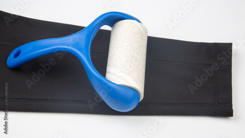 sticky plastic roller for cleaning clothes from dust, lint and hair