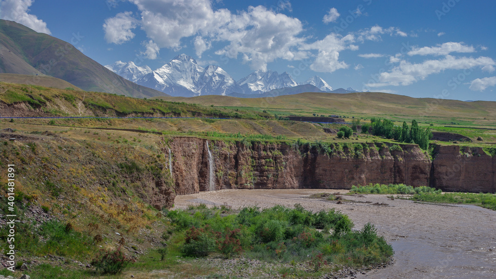 Colorful panoramic view of Ismoil Somoni peak formerly Communism peak with Surkhob river and waterfall between Jirgatal and Karamyk, Tajikistan Pamir