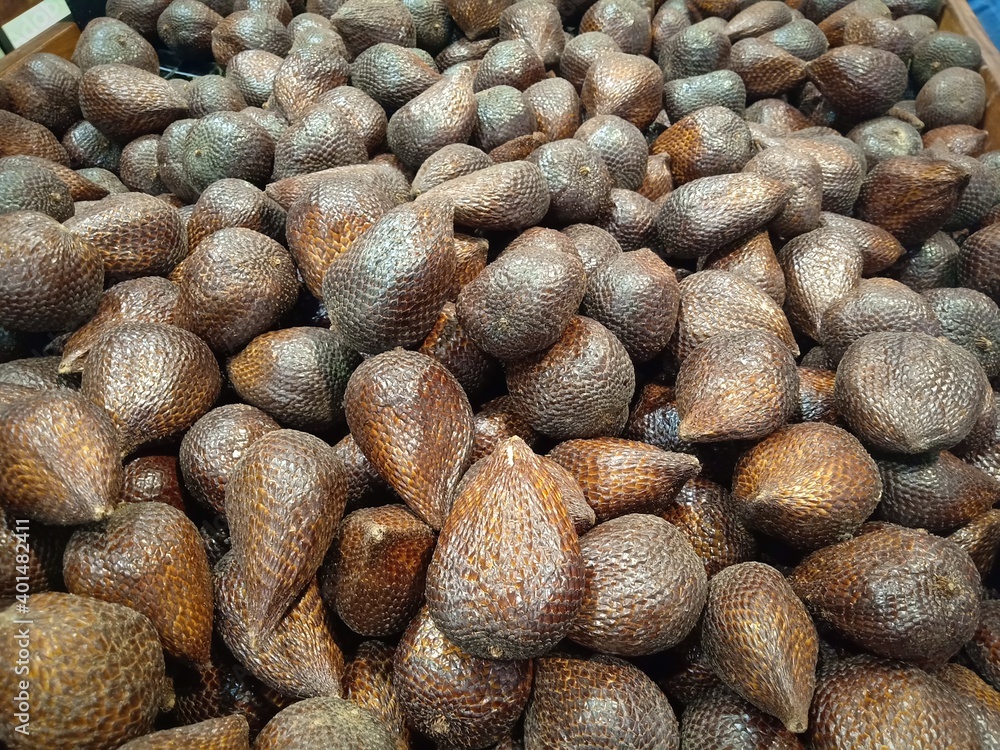 Salak fruit (Salacca zalacca) sell in the market. Salak fruit in market. Salak fruit background. Salak is sweet and sour fruit Salak fruit (Salacca zalacca) sell in the market. Salak fruit in market. Salak fruit background. Salak is sweet and sour fruit