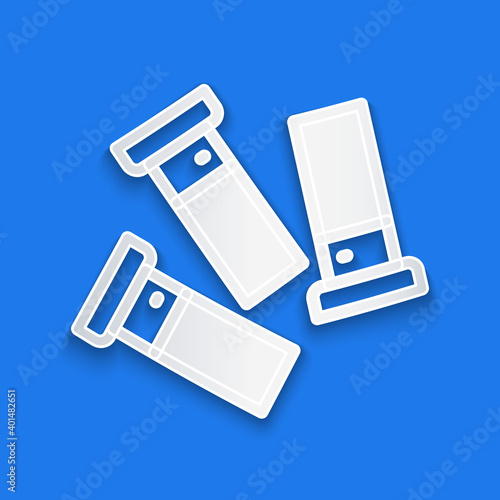 Paper cut Cartridges icon isolated on blue background. Shotgun hunting firearms cartridge. Hunt rifle bullet icon. Paper art style. Vector.