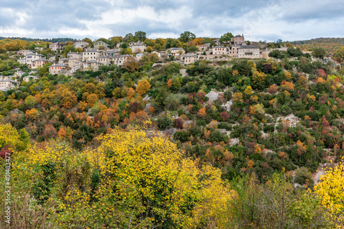 The picturesque village of Monodendri during fall season with its architectural traditional old stone  buildings located on Tymfi mountain, Zagori, Epirus, Greece. photo