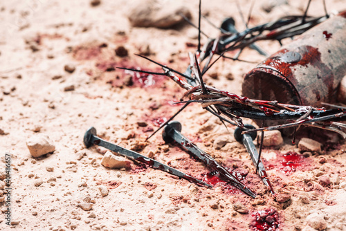 Obraz na płótnie Bloody nails, crown of thorns with drops of blood over grunged background