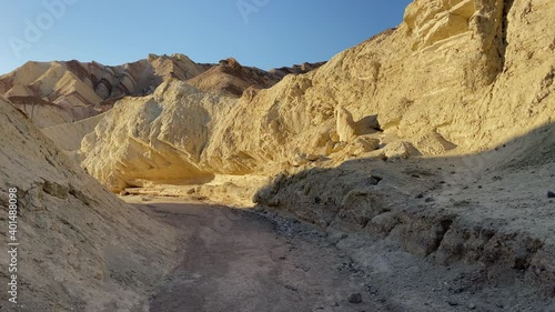 Walking at sunset at Golden Canyon at Death Valley National Park, CA, USA. Moving forward. Tracking