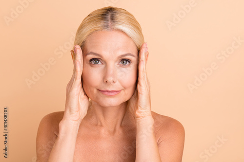 Photo of beauty uplift concept aged lady naked shoulders touch eye line uplift tightening isolated beige color background photo