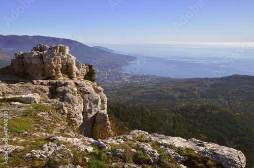 Rocks in the morning light on the mountain. The black sea, silvery clouds, the coast of Yalta