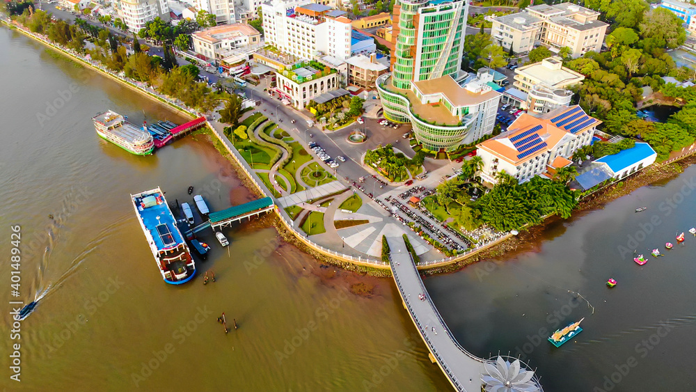 Top view aerial view love bridge or Ninh Kieu quay of downtown in Can Tho City, Vietnam with development buildings, transportation, energy power infrastructure