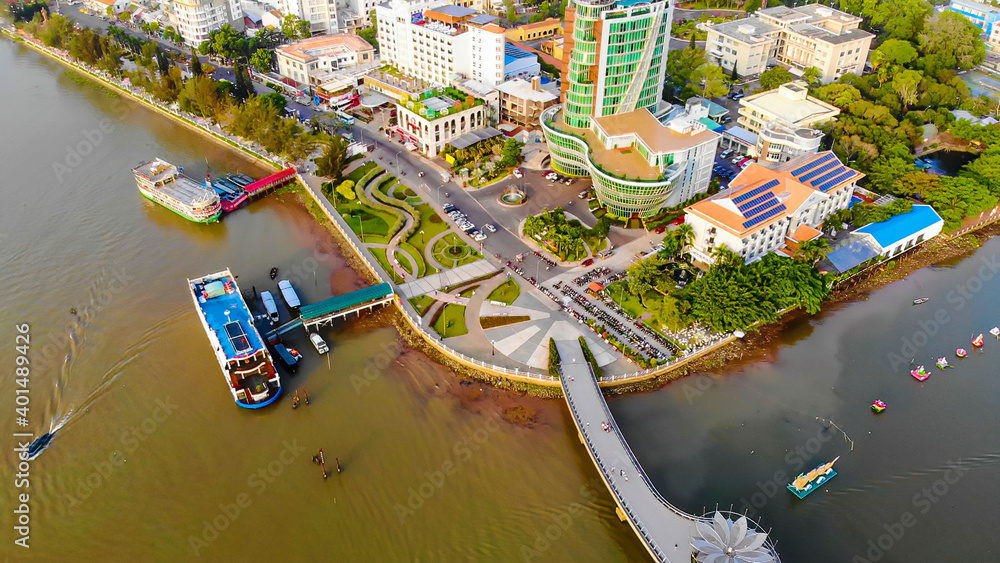 Obraz premium Top view aerial view love bridge or Ninh Kieu quay of downtown in Can Tho City, Vietnam with development buildings, transportation, energy power infrastructure