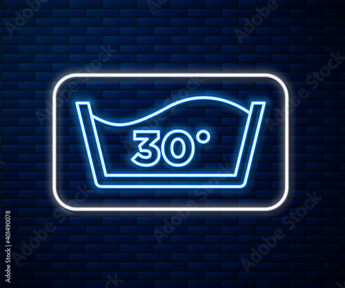Glowing neon line Washing under 30 degrees celsius icon isolated on brick wall background. Temperature wash. Vector.