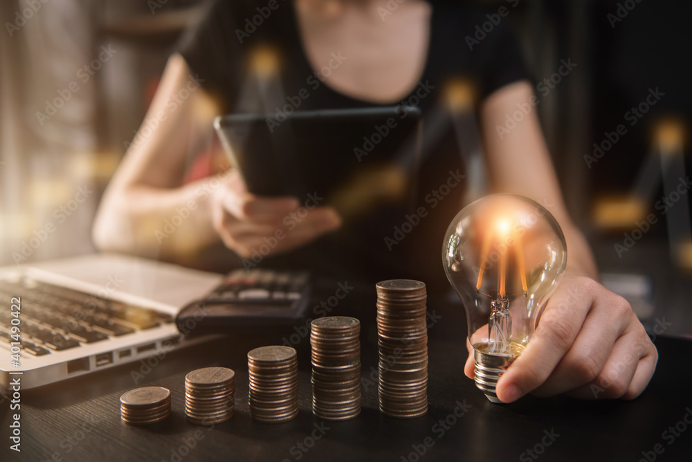 Light bulb with heap of coins stairs for financial plan or business idea concept.