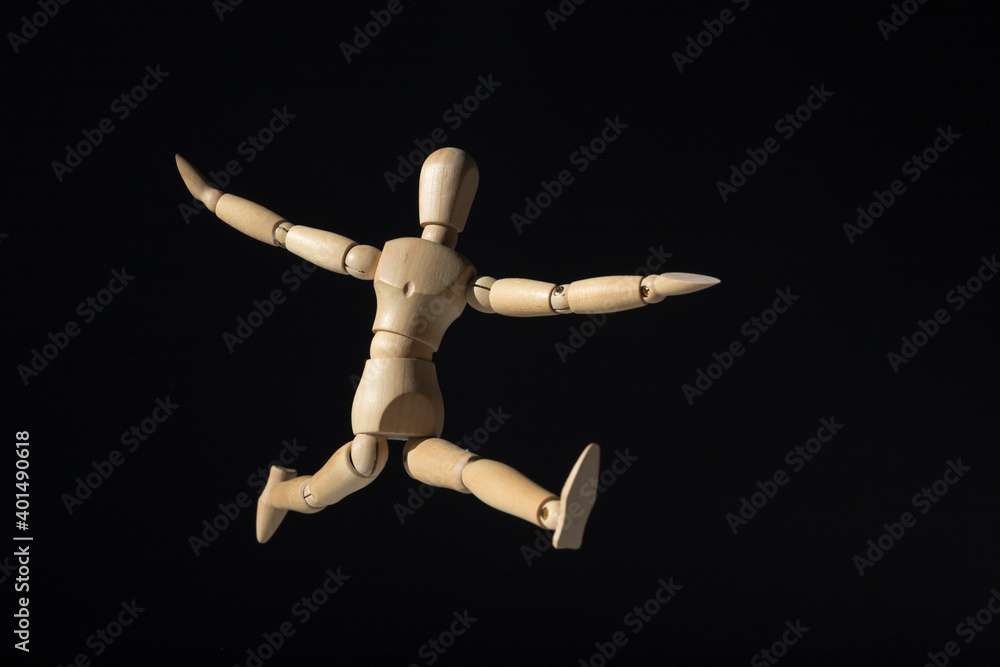 Wooden mannequin happy jump on black background. Minimal happiness concept. Wooden mannequin happy jump on black background. Minimal happiness concept.