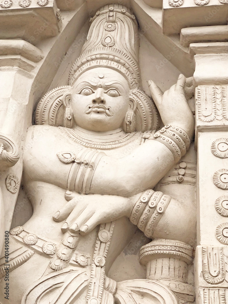 Hindu God deity statue. Ancient sandstone carved historical Hindu God