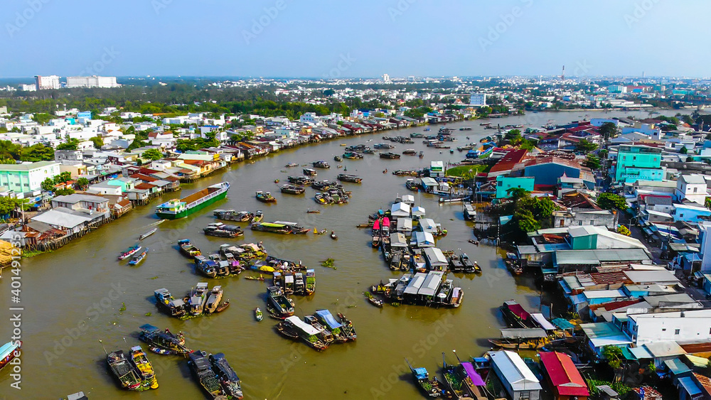 Aerial view of Cai Rang floating market, Can Tho, Vietnam. Cai Rang is famous market in mekong delta, Vietnam. Tourists, people buy and sell food, vegetable, fruits on boat, ship Aerial view of Cai Rang floating market, Can Tho, Vietnam. Cai Rang is famous market in mekong delta, Vietnam. Tourists, people buy and sell food, vegetable, fruits on boat, ship
