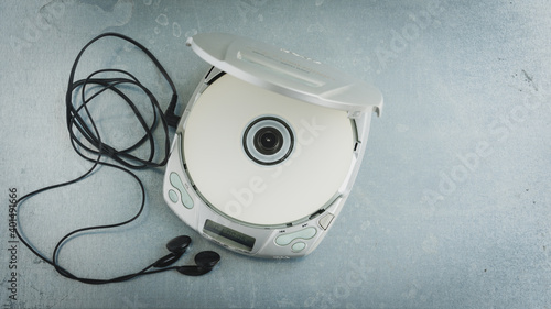 Close up of a vintage portable compact disc player on metal background.