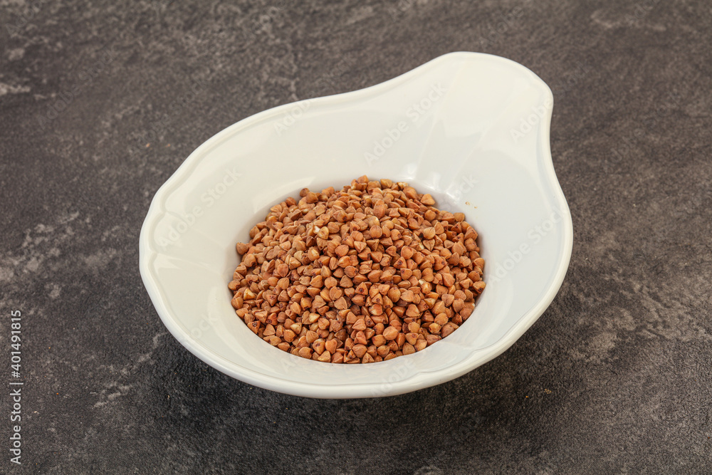 Raw buсkwheat cereal in the bowl Raw buсkwheat cereal in the bowl
