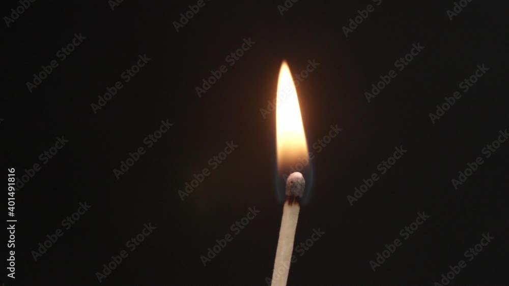 Lighting of match on dark background, closeup Lighting of match on dark background, closeup